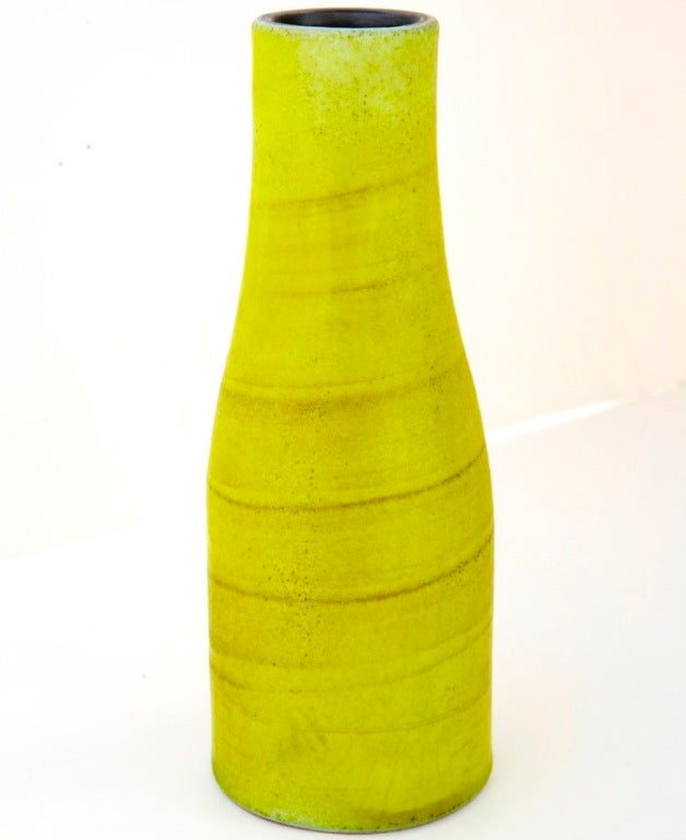 A sublime Jouve bottle-neck vase, with chartreuse glaze applied in a gentle spiral. The interior of the piece is glazed black, making an emphatic contrast with the outside surface. This piece's shape and colors are striking, as is its size (nearly