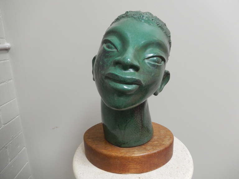 Ilyana Garmisa, a Chicago artist created this wonderful negroid bust in a decidedly modernist style, dating to 1947.

Polychromed plaster, this piece is very well executed in person. Listed artist.