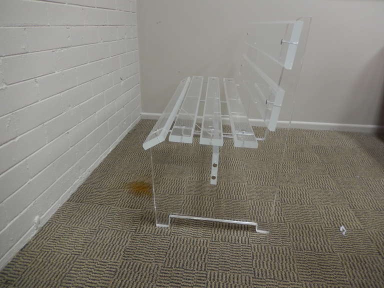 Dating to the 1970's is this acrylic, or lucite slat bench, heavy and well designed for normal use.  Elegant indoor piece. Very good original finish and condition.
