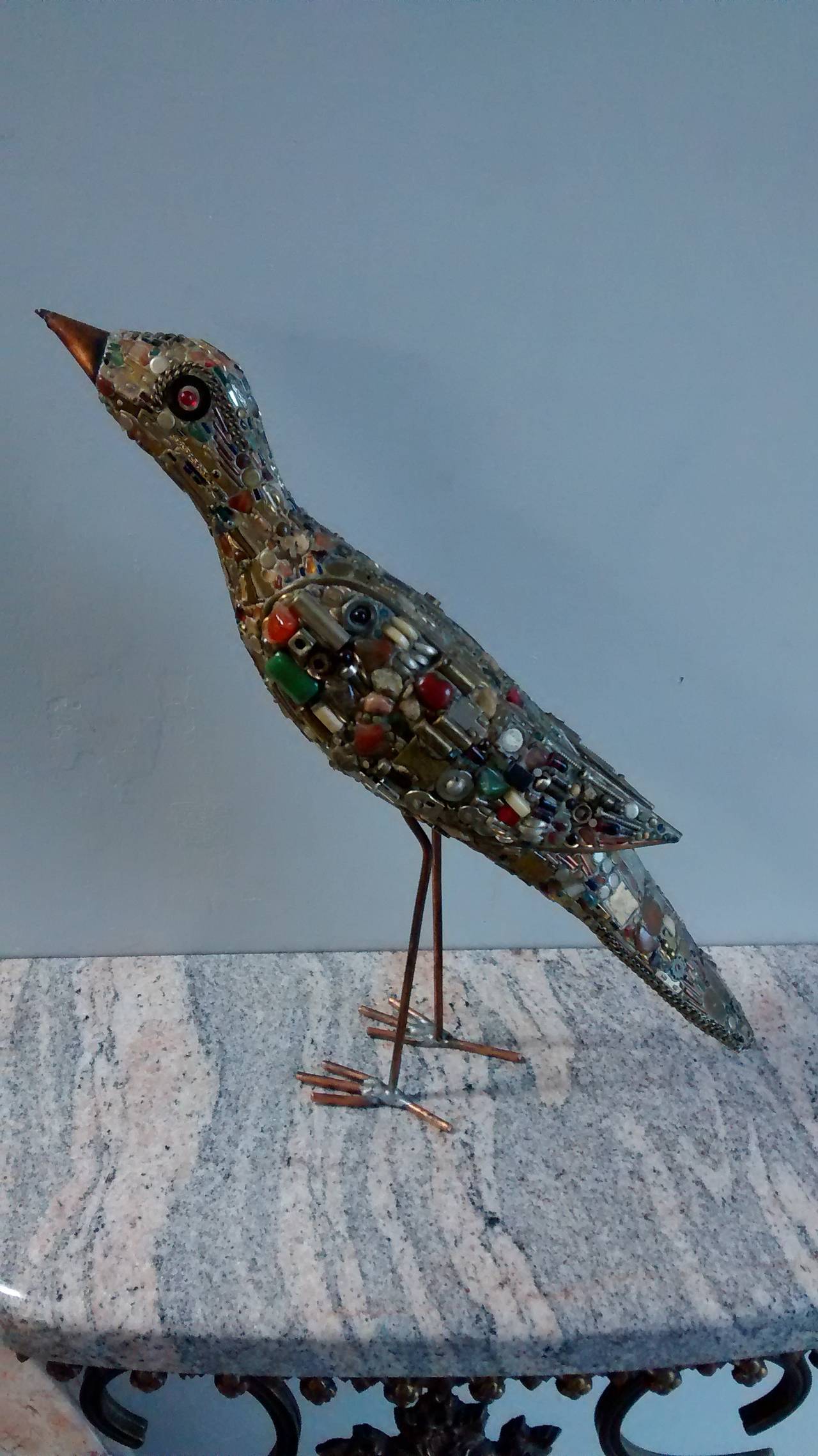 Wonderfully creative standing bird sculpture by F. Moller, dating to the early 1970's. 

Comprised of various found objects including capacitors, nuts, bolts, zippers, early computer parts, transistors, and various other items.