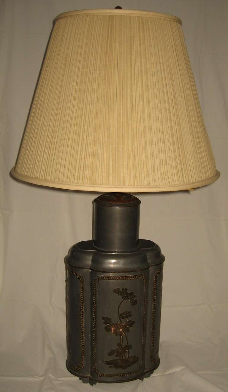 Terrific recent estate find is this vintage Frederick Cooper pewter and brass overlay Asian style tea canister form table lamp. 

Dating to the 1960's, this lamp is quite heavy and well made with brass cutout overlays depicting flora and and