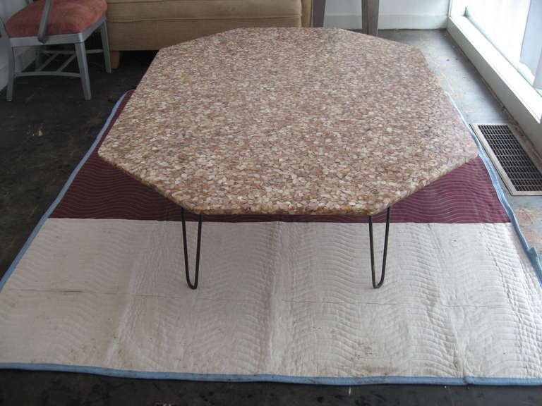 The most fabulous coffee table we've seen in years.......this estate fresh oblong octagonal coffee table is made in one giant slab of compressed abalone/paua shell and clear acrylic, and dates to the late 1950's.  

Raised on solid steel hairpin