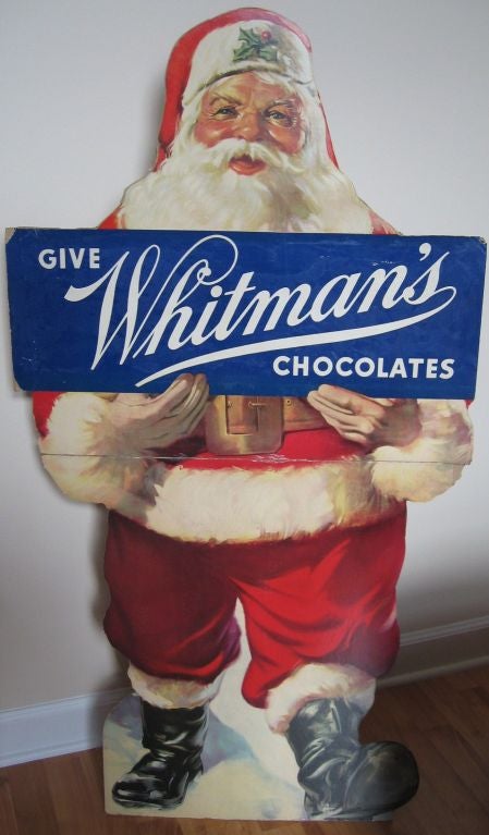 One of the best pieces of early 20th century advertising we've found in quite some time-  folding stand-up cardboard lithographic rendering of Santa Claus holding a sign for Whitman's candy. Beautifully rendered image which folds in half, and most