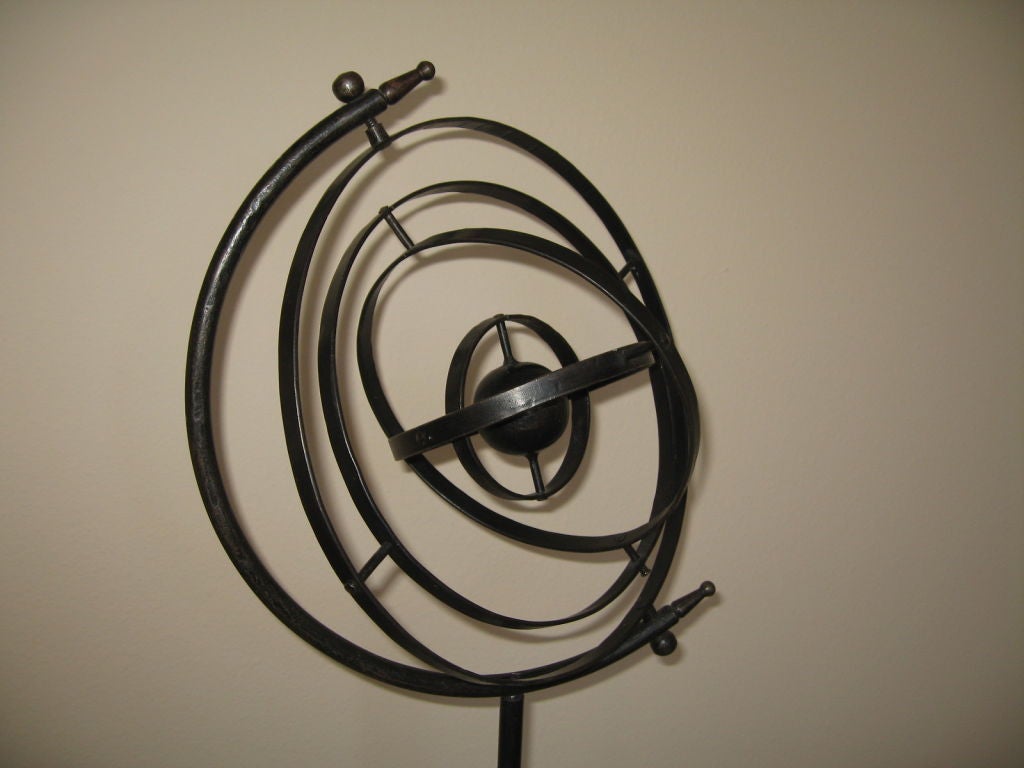Wonderful vntage wrought iron armillary or celestial sphere dating to the 1930's. Estate fresh, and made of simple iron construction, this armillary rotates easily, and is adjustable in height with a single thumbscrew. Minor signs of wear and use