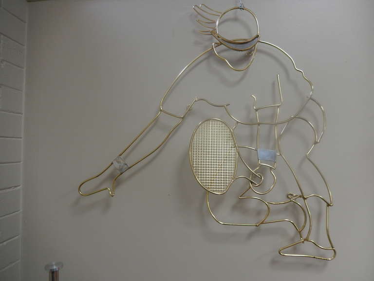 Large brass soldered, heavy gauge wire wall sculpture of a tennis player.  Great motion and in excellent condition.