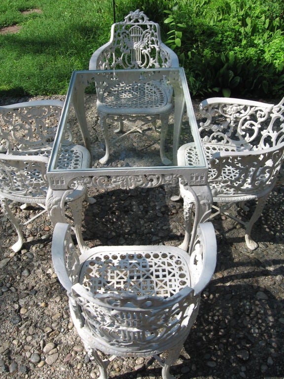 We JUST purchased this set this week, and photographed it in it's original setting. Superb late 19th century outdoor garden set rendered in cast iron with some of the most amazing detail we've seen in a long time. Neoclassical lyre back chairs are