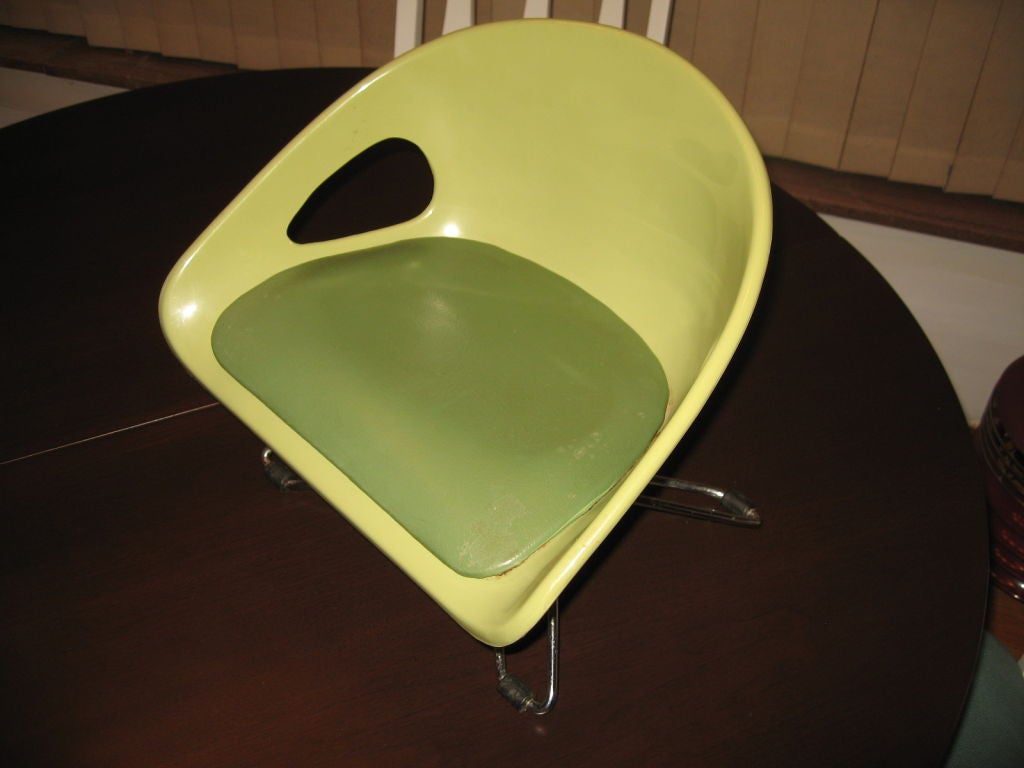 Never have seen one of these before-  cool little tykes booster seat shell chair in pea green fiberglas and avocado vinyl, dating to the 1960's. Pseudo Eiffel Tower style adjustable base in chrome over steel. Still durable and in excellent