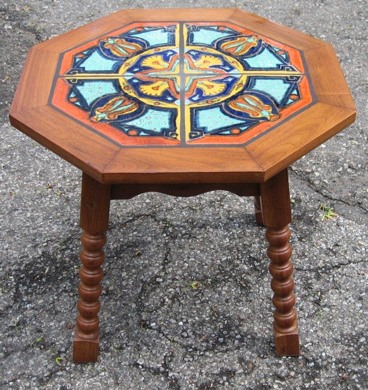 Superb octagonal tile top table made in the California arts and crafts tradition, dating to the 1930's.  Rendered in hand turned oak and walnut framing, this little table is comprised of four large tiles decorated in a kaleidoscopic pattern done in