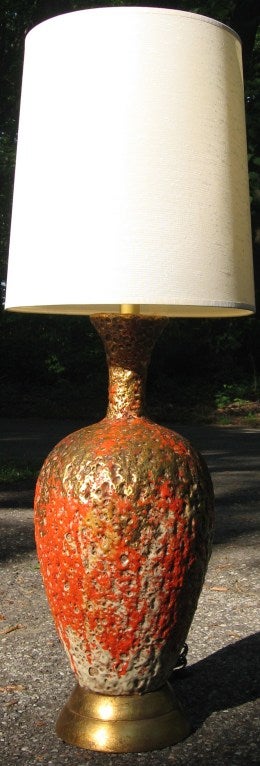 Fantastic Italian lava glaze table lamp, dating to the 1950's.  Very thick and heavy piece, the body is one of the most successfully executed glazes we've seen in a long time, utilizing colors of deep orange, gold and white.  Base is gilded metal.