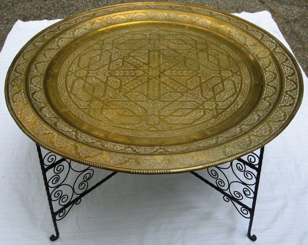 Large Moroccan made tray table, bought by the original owners on a trip there in the 1950's.  

Estate fresh piece from Bloomfield Hills, Michigan, this table is comprised of a solid brass hand chased tray top in a beautiful design reminiscent of