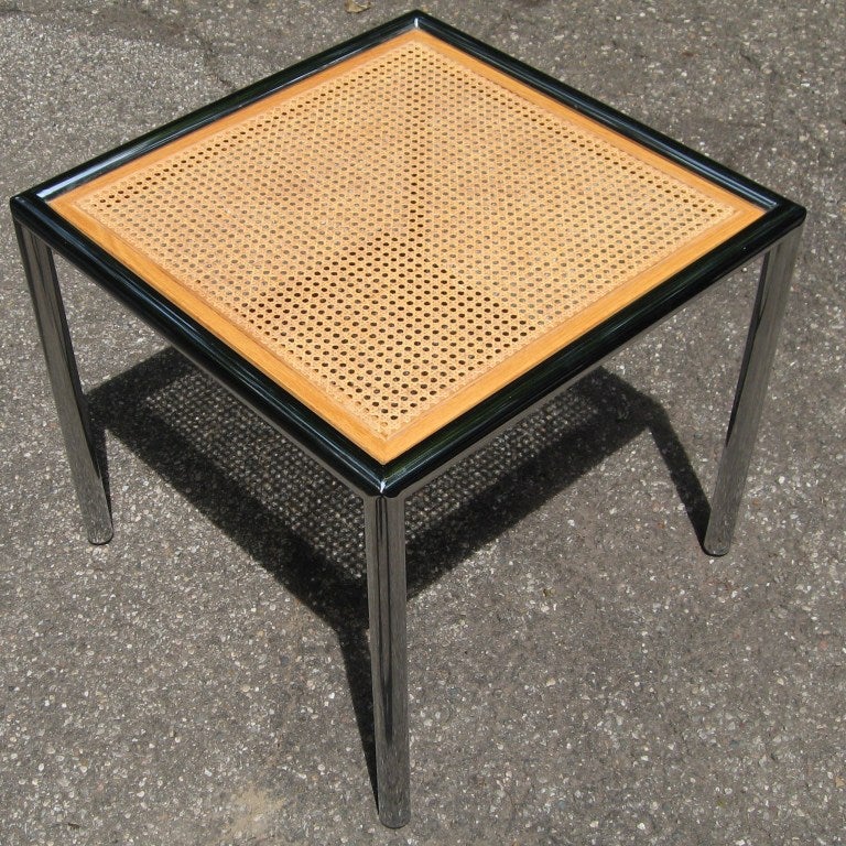 Superb heavy duty Milo Baughman designed end tables for the Design Institute of America, dating to the early 1970's.  

Rendered in chrome plated steel with glass topped caned inserts, the framing on these are reminiscent of chromed automobile