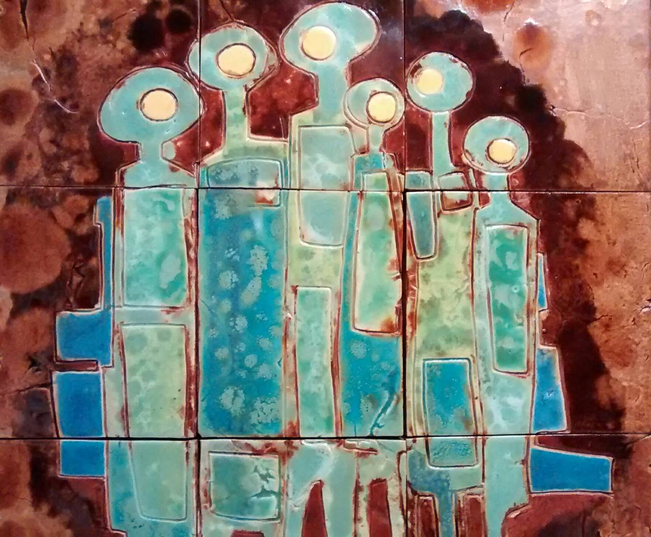 Super nine-tile wall hanging by modernist ceramic artist Mary Blakley (1914-2004). 

This work, dated 1974, depicts a group of humanoid figures in what is a very strong, modern aesthetic. 

Below is an excerpt from an online biography on the