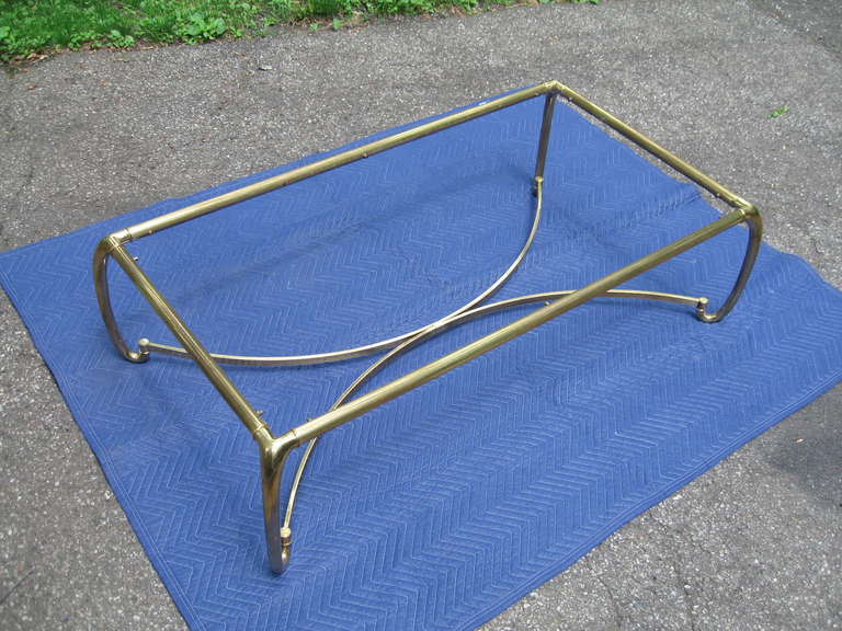Elegant, solid burnished brass coffee table by Mastercraft for Baker, dating to the early 1970s. This table measures an impressive 60