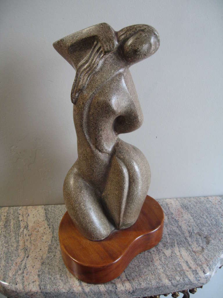 Lovely modernist female form sculpture once shown at the Minneapolis Museum of Art in the late 1940's.  Unfortunately we can't read the artist's name on the tag, but it is present and taped to the bottom. 

Rendered in a form of cast terrazzo,