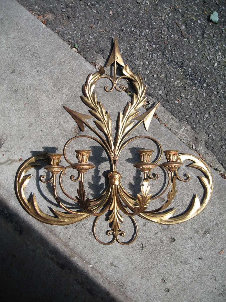 Superb pair of Palladio, Italian imported candle sconces, dating to the late 1950's.  

Rendered in gold leafed steel with wooden bobeches, this pair retain their original finish and are in excellent condition.  

Original metal 