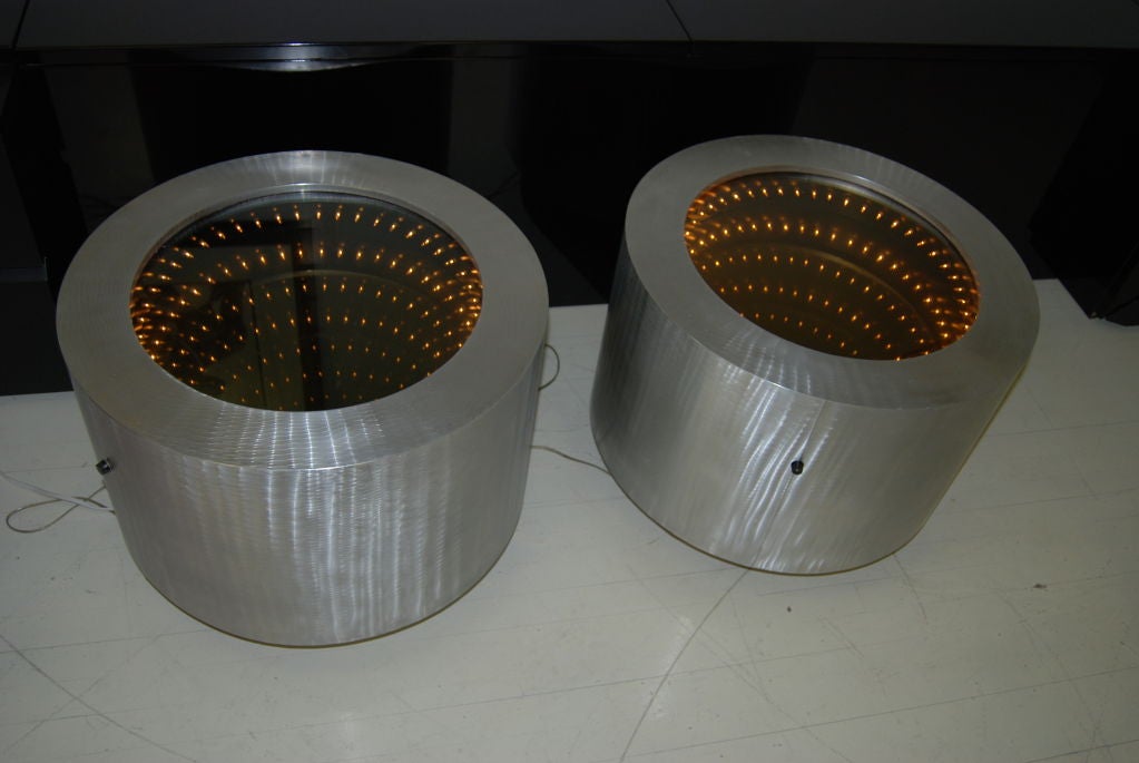 Pair of circular infinity mirror side tables executed in brushed aluminum.Tables have on/off side control switch. Perfect for living room ,den or bedroom.Super fun! Please note:Price is for the pair.
