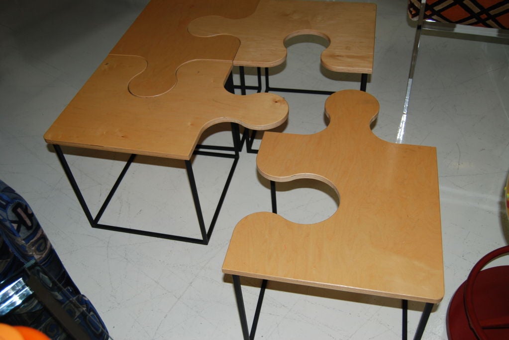 Square coffee table in the form of a jigsaw puzzle. Executed in beautiful maple wood on four individual square black metal bases. Separate and utilize as four individual drinks tables, or connect the pieces and utilize as a square coffee table.