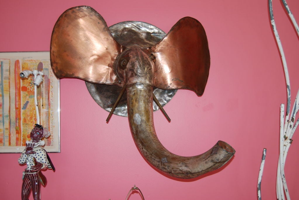 Fun! dimensional life-size elephant wall sculpture executed in mixed metals. Enormous head measuring 48 inches high and extends 30 inches from the wall. Perfect with Mid-Century Modern decor. Great for indoors or outdoors on a covered terrace or