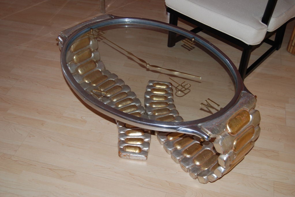 Incredible Italian hand crafted coffee table in the shape of a wrist watch.The top of the table is designed with two pieces of glass inset into a steel frame with  brass hardware.Band is executed in silver and gold leaf over wood.Signed with