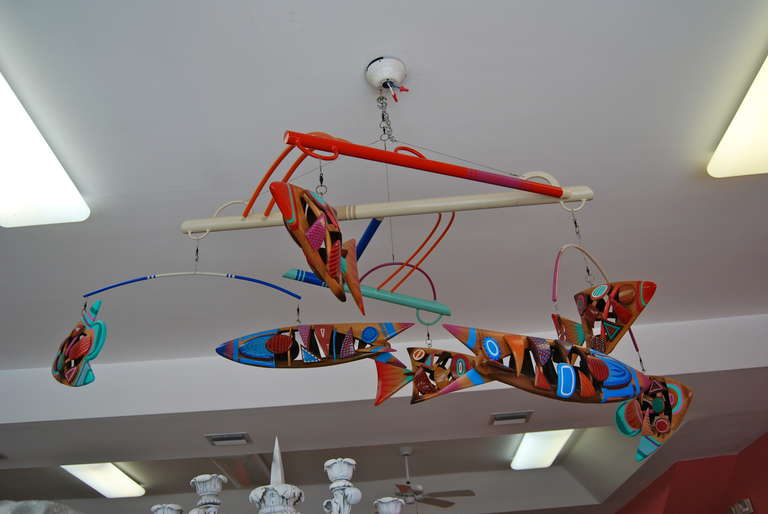 Large hanging mobile by Daniel Meyer depicting a group of modernist fish. Each individual fish is expertly handcrafted in multiple pieces of wood with an enamel paint finish, and high polished with a gloss lacquer coating. The mobile is suspended by