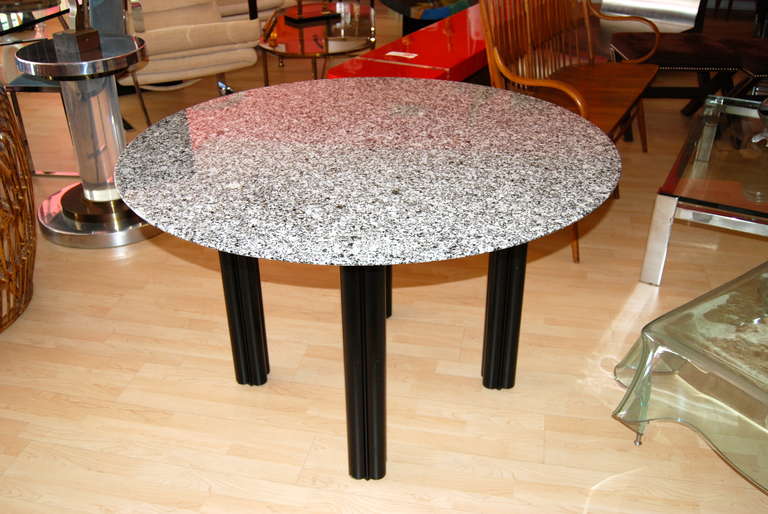 Memphis era designed dining table or center table executed in flat black enamel steel legs with a round black and white reverse bevel granite top.