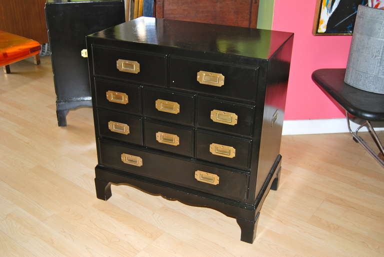 Classic pair of campaign chest with brass hardware. Chest are designed with nine drawers for ample storage. Chest are finished on back and are perfect as end tables or bedside tables. Great size and height. Tables will be expertly refinished in your