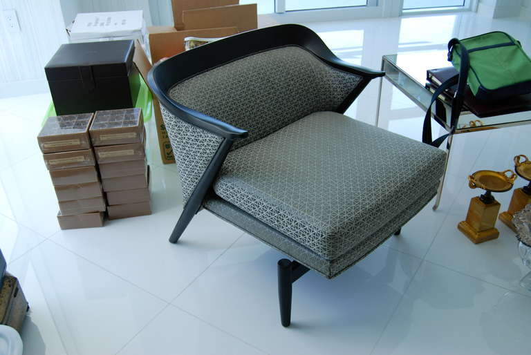 Pair of Mid-Century club chairs executed in a matte ebony finish with beautiful gray upholstery as shown.