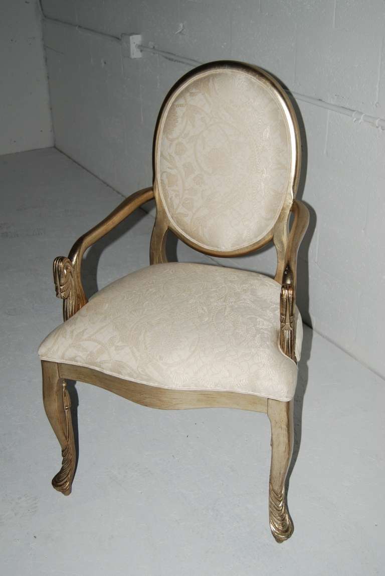 Set of eight Italian dining room chairs executed in silver leaf. Great carved detail to front or arms and legs as shown.