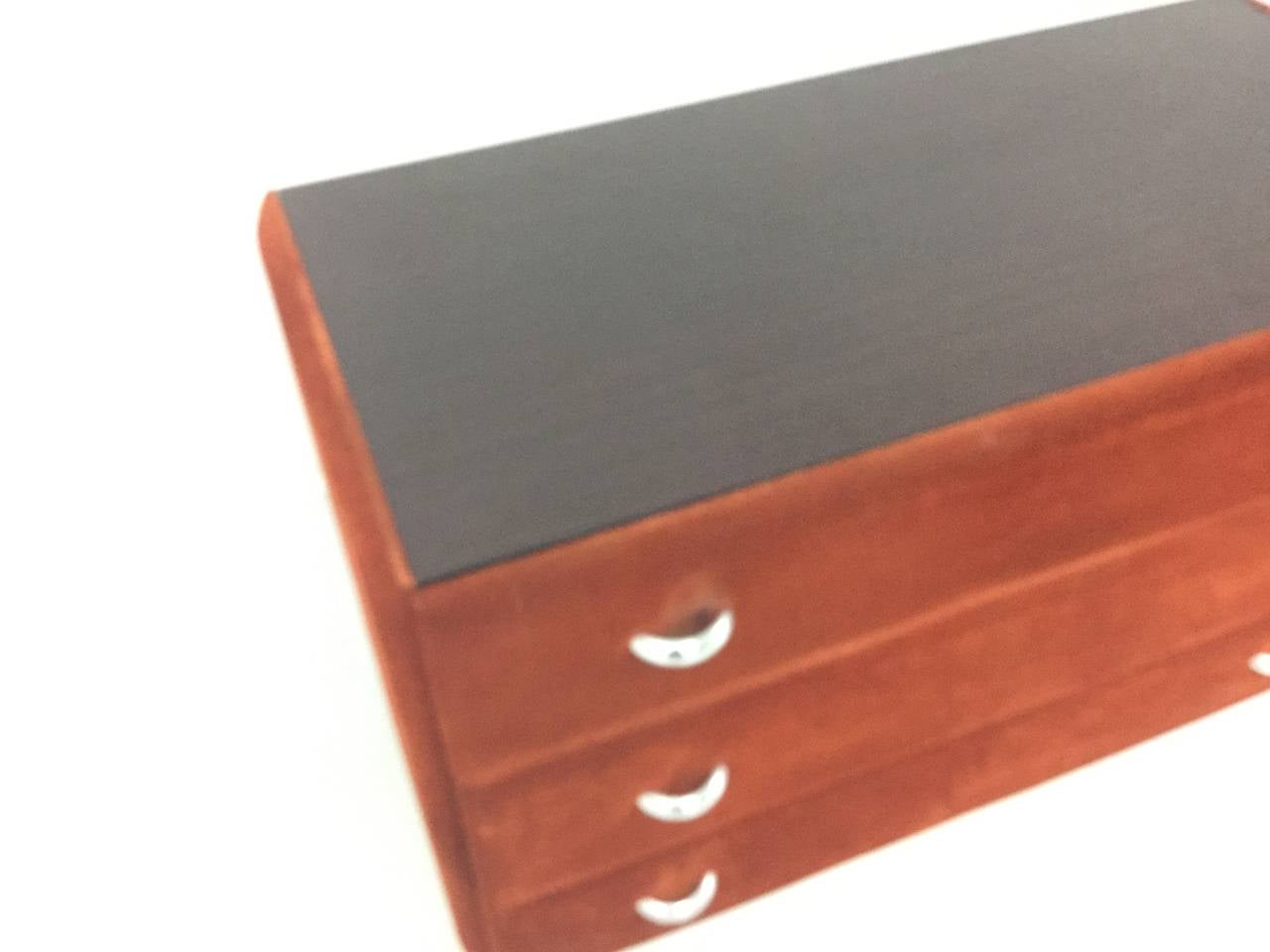 Suite of three genuine suede chests from Italy with chrome bases and faux rosewood tops.