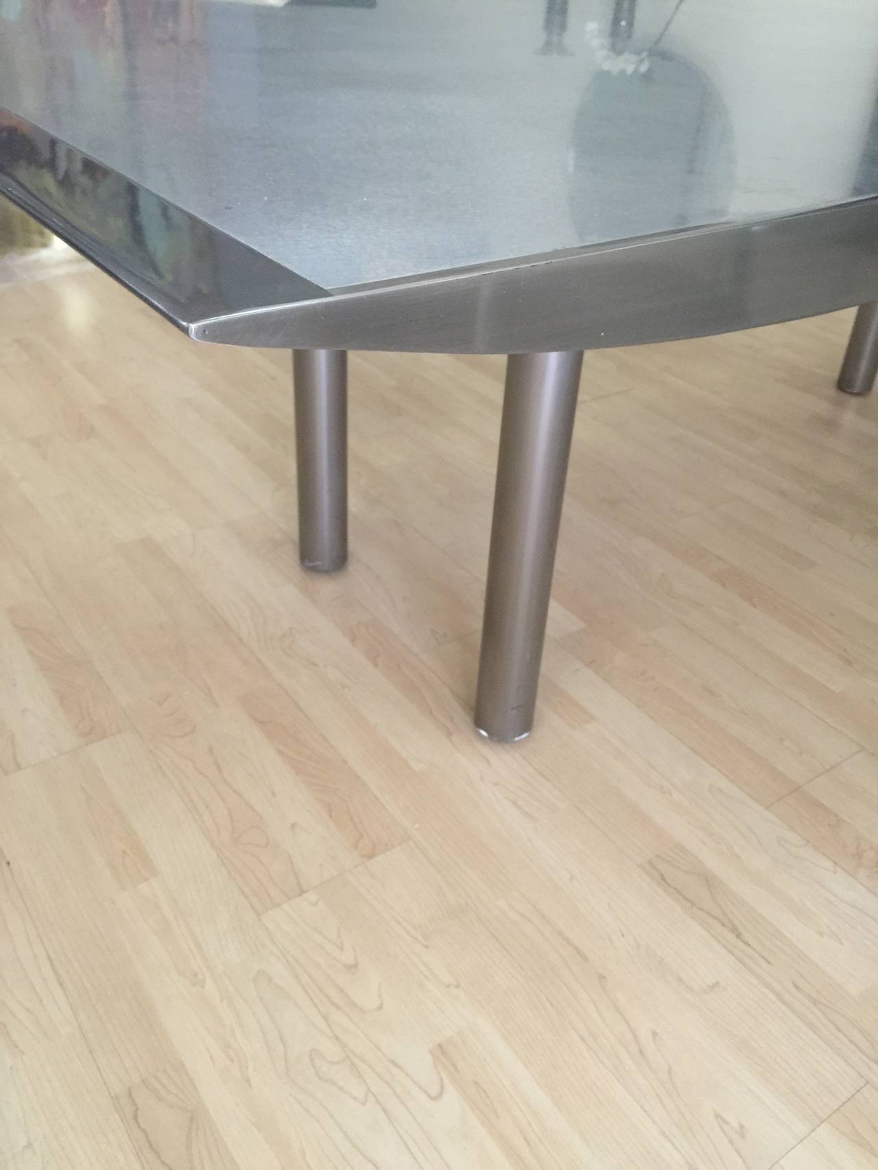 This is the SS 2000 table finished in satin stainless steel with an orbital brushed stainless steel surface. Designed by Stanley J Friedman. The satin finish is in nice condition. It has a few rub marks to be expected.