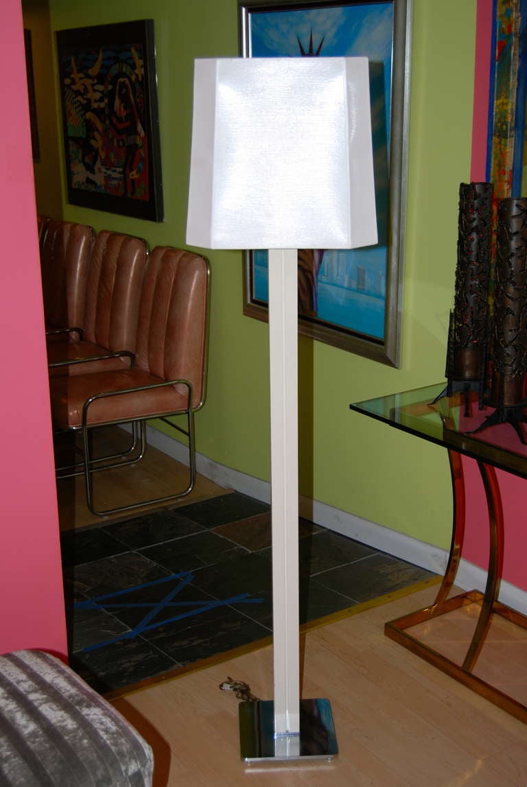 Karl Springer polished steel floor lamp with original ivory lacquered wood finish and shade. Great channeled column design.Lamp has two light sockets with an additional custom center torchiere  for maximum light.