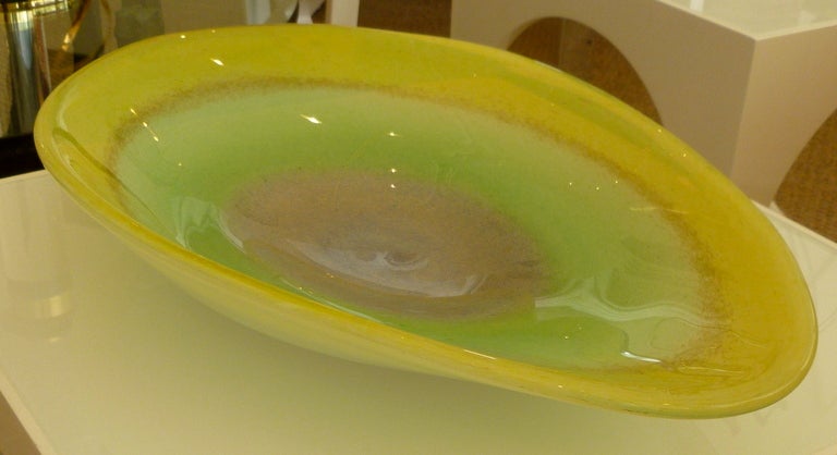 This most beautiful and arresting colors of this large and heavy bowl/platter/centerpiece goes from lemoncello yellow to apple green to purple with gold aventurine bullseye center and is perfect for any centerpiece , coffee table or counter. The