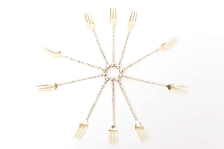 Twist and ball. All hallmarked sterling silver cocktail or serving forks. They are very sculptural and were way ahead of it's time.... when they were made...
They all have a gilt wash on the top part of the fork section.
The twist and ball feels