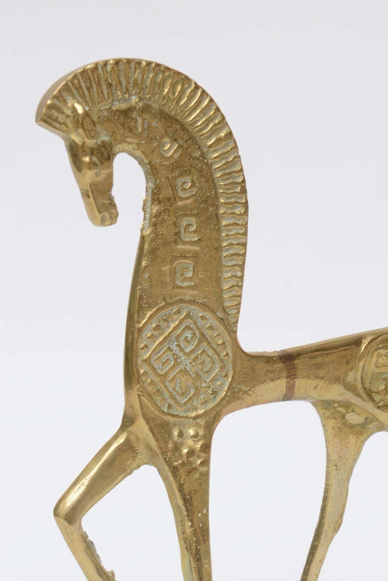This wonderful decorative and heavy cast bronze etruscan horse sculpture/object
looks like it is in beginning of galloping walk.
the details are wonderful. It is in the style of Frederic Weinberg.