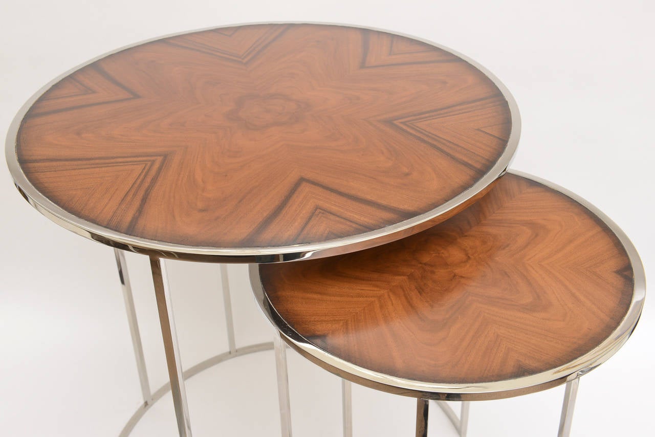 These two different sizes of nesting tables have the most beautiful matchbook italian exotic wood on top. They also have a marquetry look. We do not know the exact wood but it is very special. It forms an abstract flower pattern on each table
The