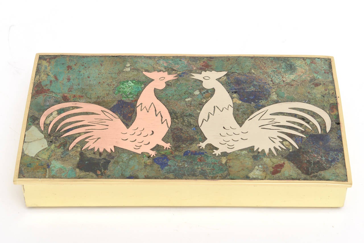 This wonderful unsigned but hallmarked Hencho en Mexico hinged box has two delightful roosters ; one in copper one in silver against the mixed stones of lapis, sodalite and turquoise. The interior is rosewood and the bottom and sides and hinges are