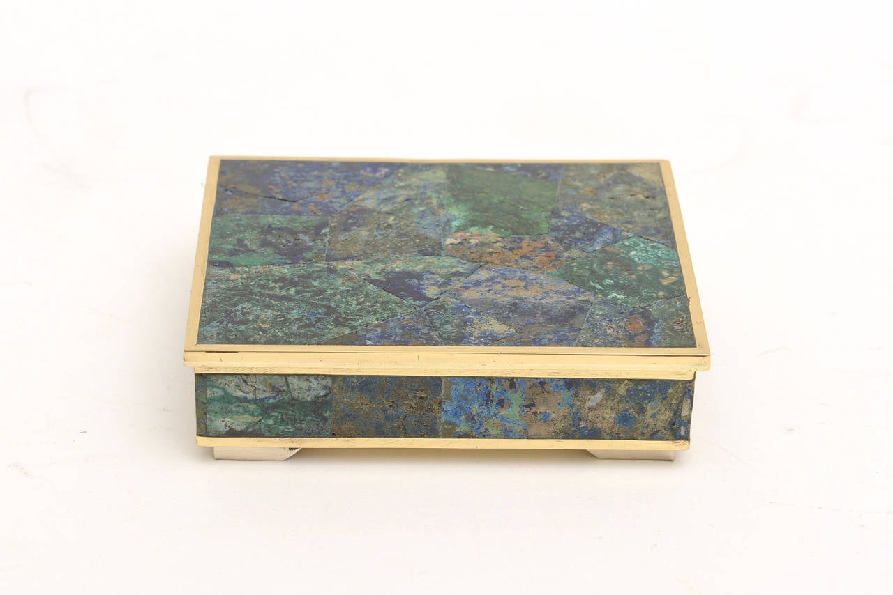This lovely Mexican hinged vintage box or pillbox has polished brass on the bottom and all around the mixed stones. The colors are a beautiful array of greens, to blues to turquoise from the mixture of all the different stones. Like the sea... and