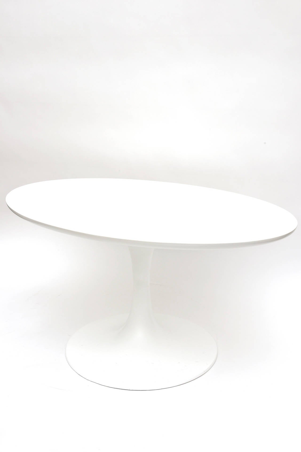 This unusual vintage oval low side or cocktail by Eero Saarinen for Knoll tulip table is Classic!!!
It is simple, period and original. It has been restored. All beautiful and clean white! It is made out of cast iron, laminate and wood.