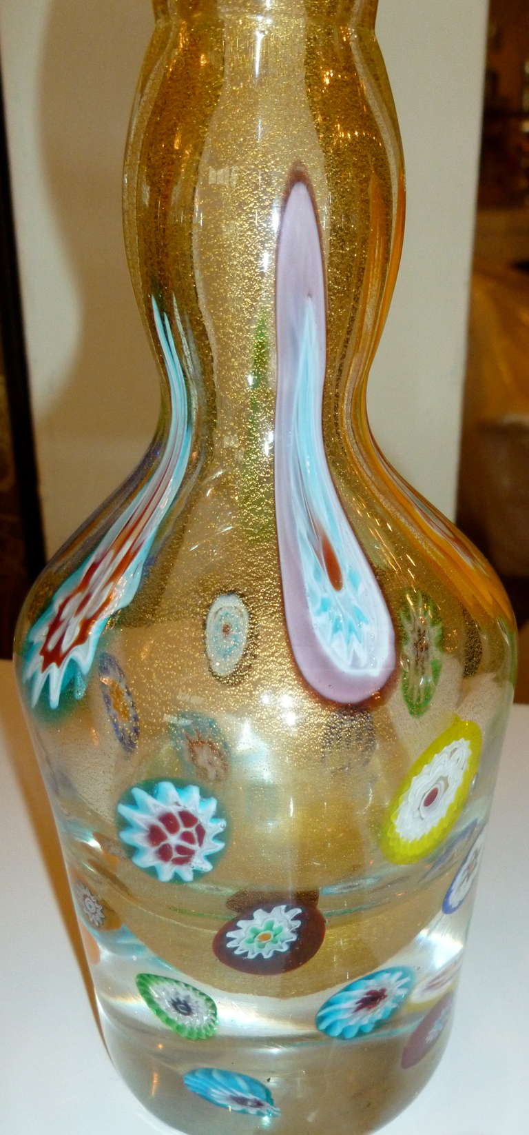 This stunning Italian Murano Mid-Century Modern glass decanter or perfume bottle by Fratelli Toso is so rich looking and has the most luscious colors of murrhine canes. The gold aventurine is abundant and rings with gold. The colors are plentiful