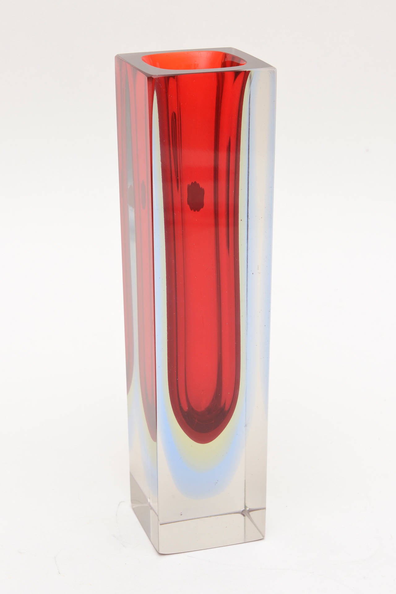 This lovely Italian Murano paper labeled Mandruzzato glass vase has the flat cut polished square top. It has the Sommerso with the faint yellow and blue bottom.
The red is rich and brilliant. It has the original paper label.
Square all around and