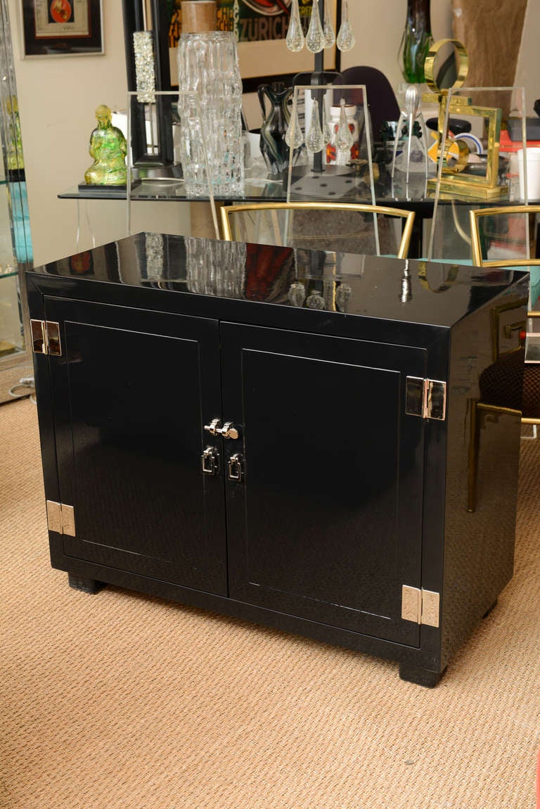 These simple handsome yet modern yet functional pair of newly restored commodes/night stands/ end tables/ cabinets are black lacquered and have nickel silver modernist hardware from the period.
The hardware is original and nickel silvered.

These