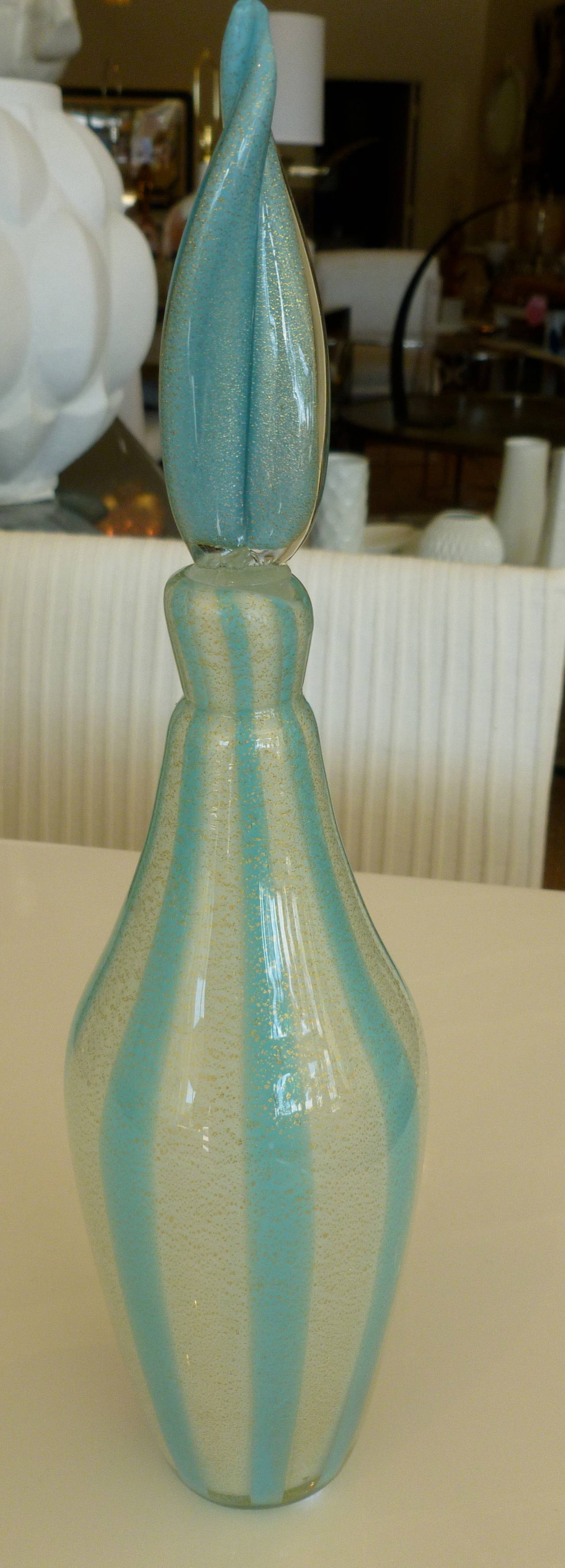The lovely stripes of light turquoise and off-white meets gold aventurine in this beautiful Italian Murano glass bottle with original flame stopper by Italian maestro Alfredo Barbini.
It is the tent design.