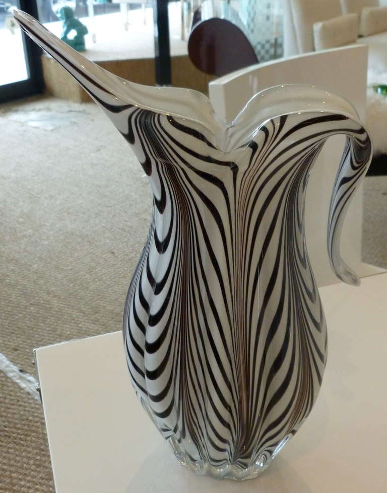 4 layers of beautiful sommerso in white ,black and amethyst make up this dramatic vase that looks like zebra.... It is Italian by Salviatti from the 60's. It is called the 