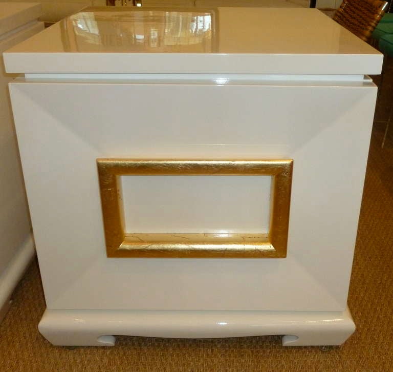 These LARGE pair of period white lacquered and gold leaf
end tables or night stands are not only high, but very wide and very
deep... The square pull is all beautifully real gold leafed that opens
the door... it has a bit of James Mont feel....