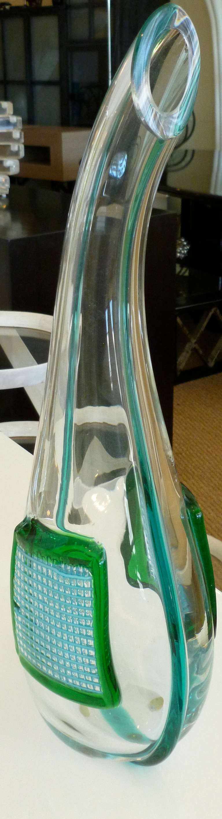 This one of a kind work signed by the eminent Italian Murano artist: Massimiliano Schiavon has the luscious colors of the sea in turquoise and greens applied grid square against the clear glass. The raised and textural glass on both sides is