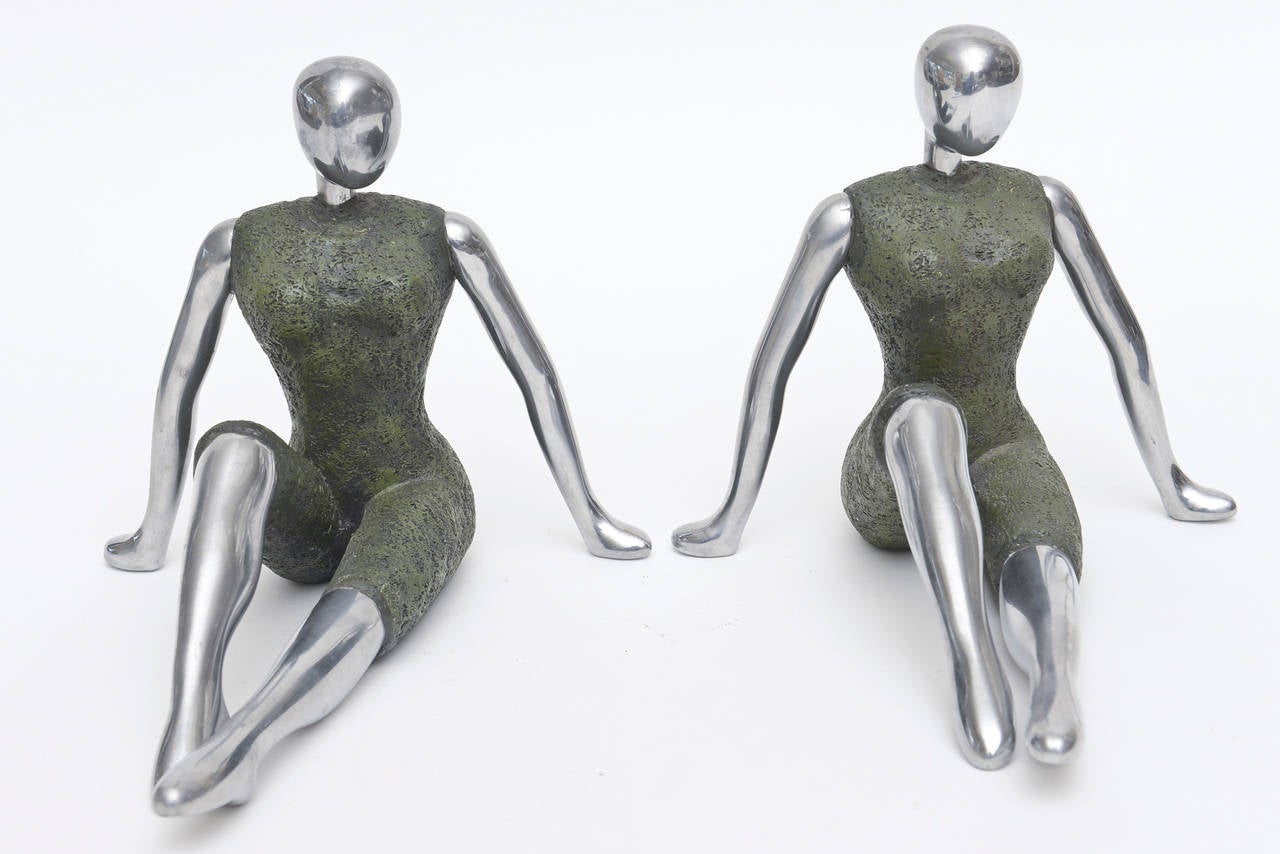 These wonderful female form pair of bookends are heavy aluminum and painted metal as the clothing. They border mannequin looking vs modernist.
They can just be objects on a table or console.