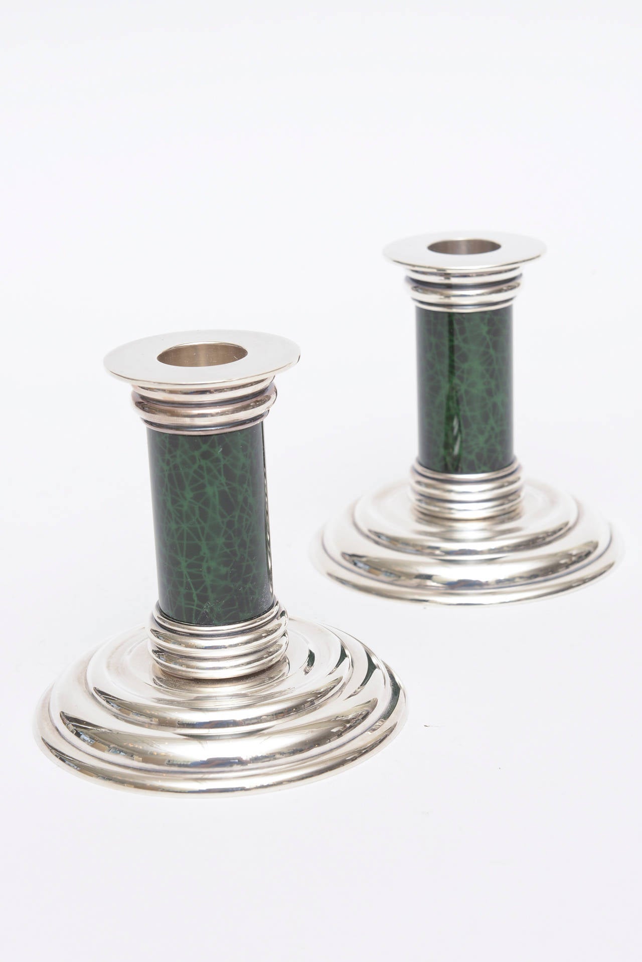 These lovely hallmarked Jean Puiforcat Art Deco pair of small candlesticks have stepped bottom and top. They are silver plate and malachite enamel in the center.
They have the Puiforcat maker on the bottom; all hallmarked.
These are small, lovely