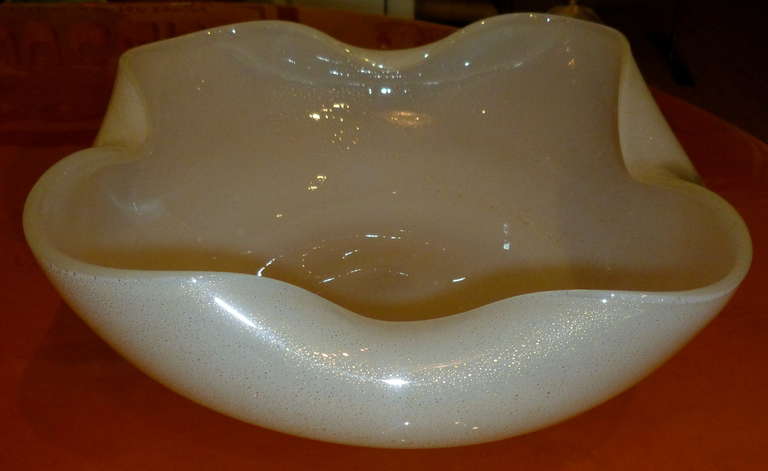 A very old process of blown partial combination of white paste primavera glass with gold aventurine makes this bowl gorgeous! It is part white opalescent meets milk with gold.......The partial original Seguso foiled label is still intact on the