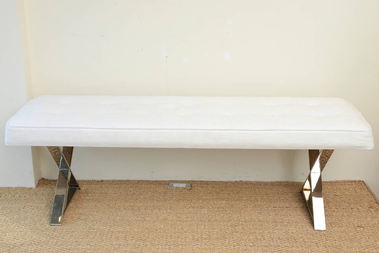 This versatile simple, chic and moderne bench is long. The chromed over steel X-frame has been newly upholstered with a white linen/cotton fabric.
There are two rows of buttons totaling 14; 7 on each row.