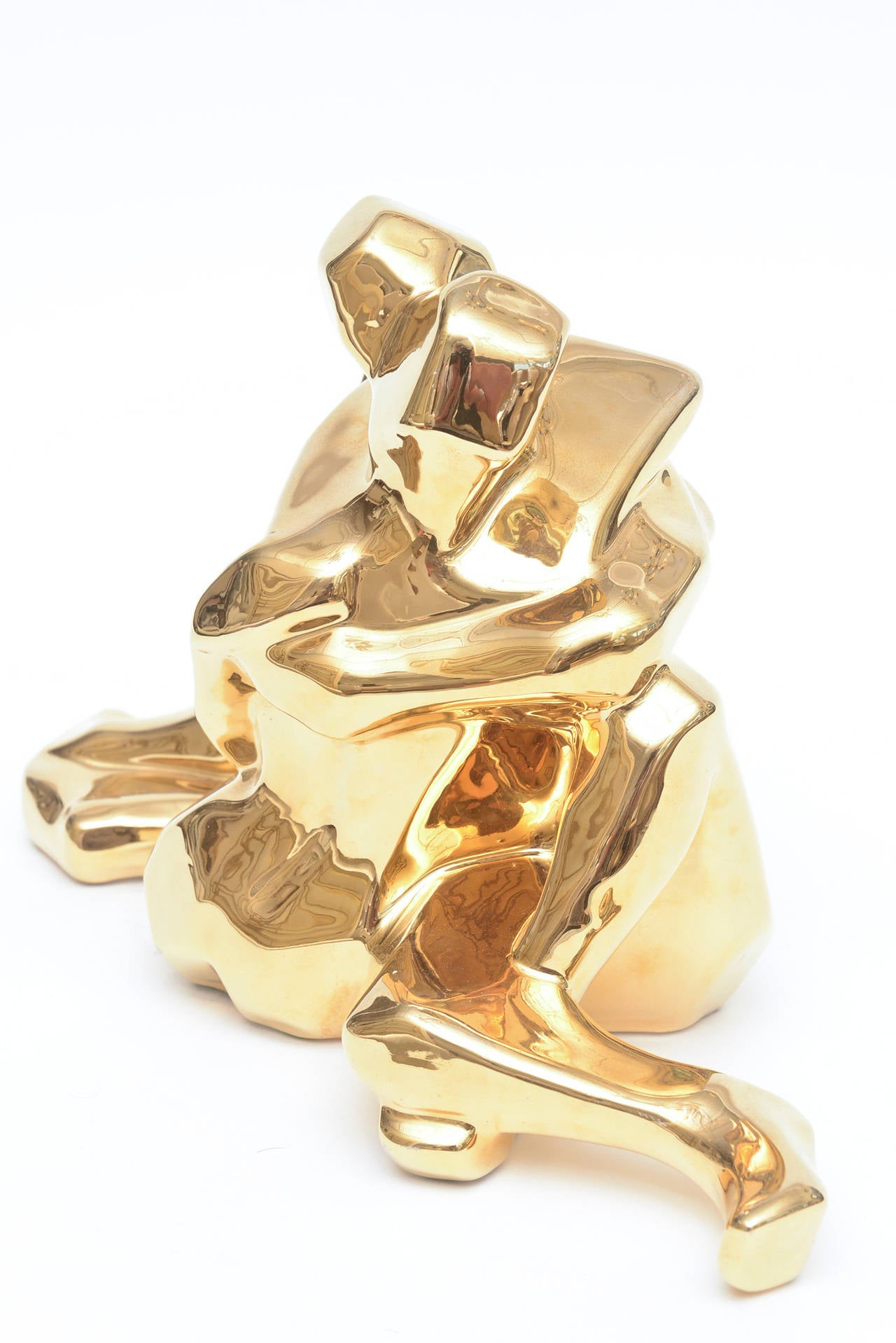 The gold plating over the ceramic is rich with attention...and intention..
The cubist form of the two lovers is romantic.
A great sculpture from the California based company from the period. It is signed and dated with the original sticker on